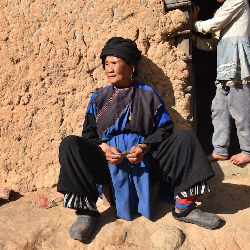 Lesu Grandma at in front of her traditional house